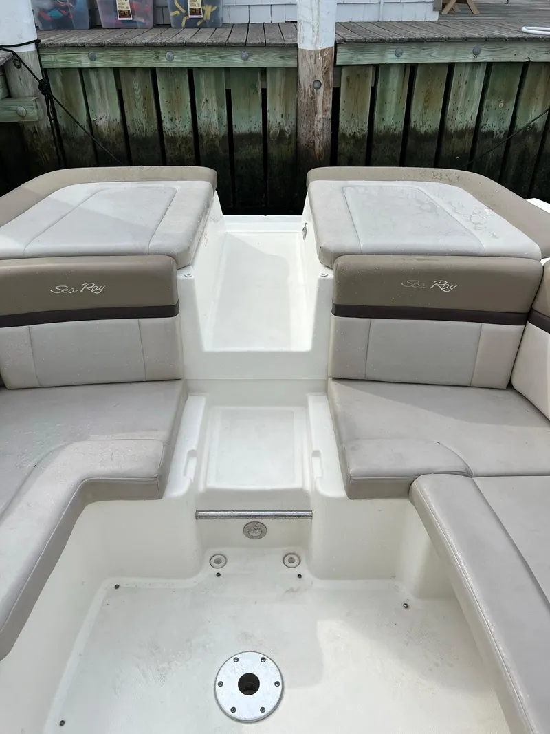 Slide: The Image of 2011 Sea Ray 270 SLX boat interior with cushioned seating and storage compartments. - 19