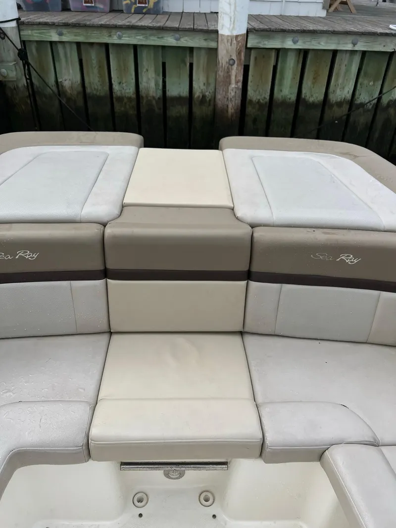 Slide: The Image of 2011 Sea Ray 270 SLX boat seating area with beige and brown upholstery. - 21