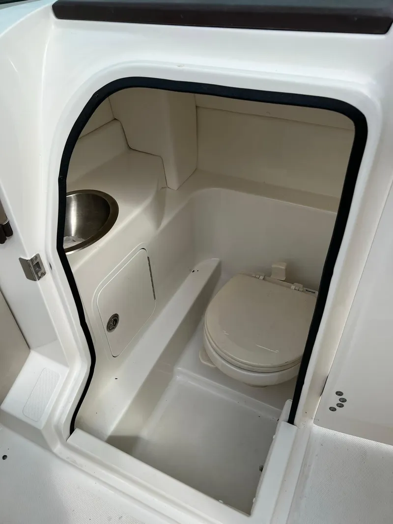 Slide: The Image of 2011 Sea Ray 270 SLX boat interior with compact bathroom and sink. - 3