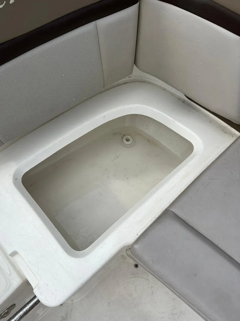 Slide: The Image of 2011 Sea Ray 270 SLX boat interior storage compartment with cushioned seating. - 5