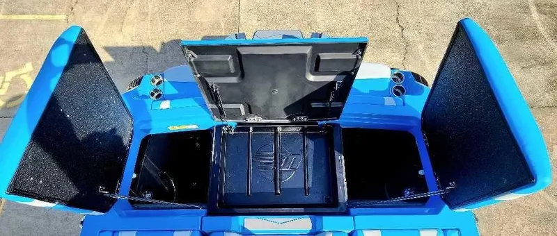 Slide: The Image of 2024 Malibu Wakesetter 23 MXZ storage compartments open, showcasing spacious interior. - 10