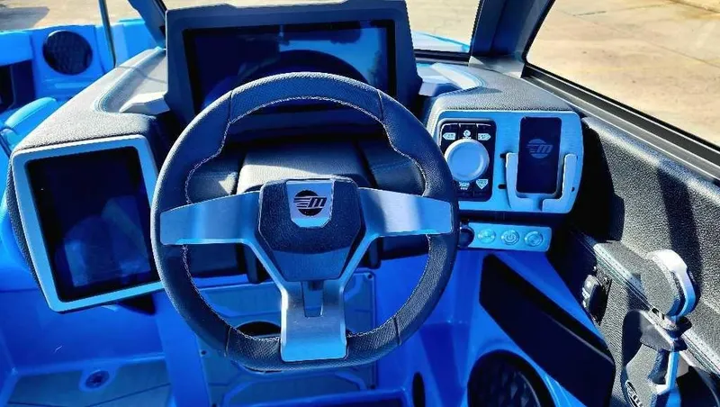 Slide: The Image of 2024 Malibu Wakesetter 23 MXZ dashboard with steering wheel and control panel. - 17