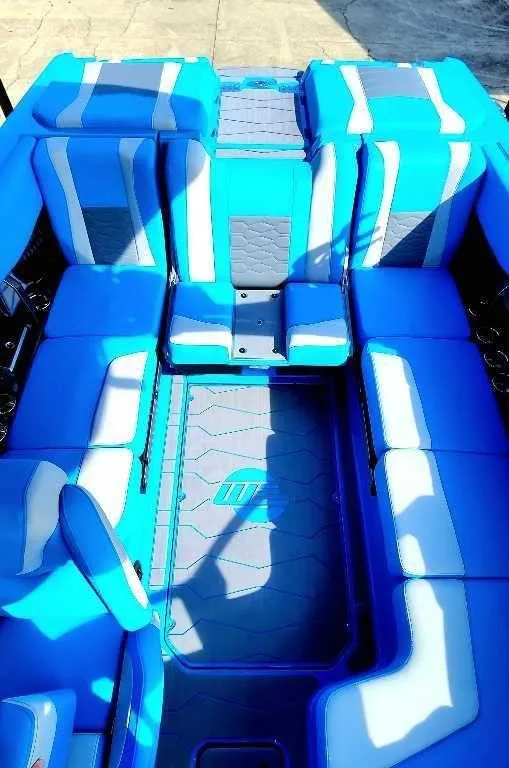 Slide: The Image of 2024 Malibu Wakesetter 23 MXZ interior with blue and white seating. - 3