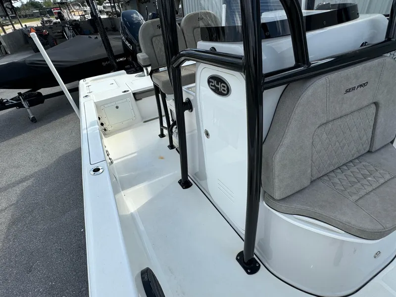 Slide: The Image of 2024 Sea Pro 248 boat interior with seating and console, showcasing modern design and features. - 11