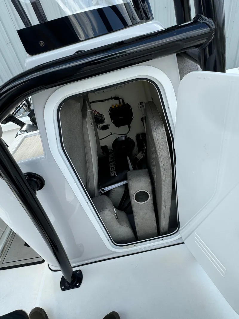 Slide: The Image of 2024 Sea Pro 248 boat storage compartment with seating and cup holder. - 12