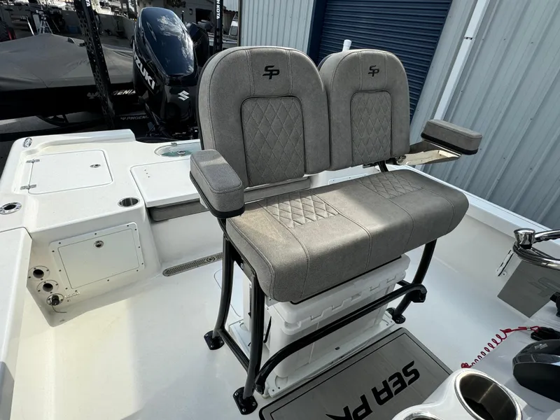 Slide: The Image of 2024 Sea Pro 248 boat interior with dual seats and storage compartment. - 13
