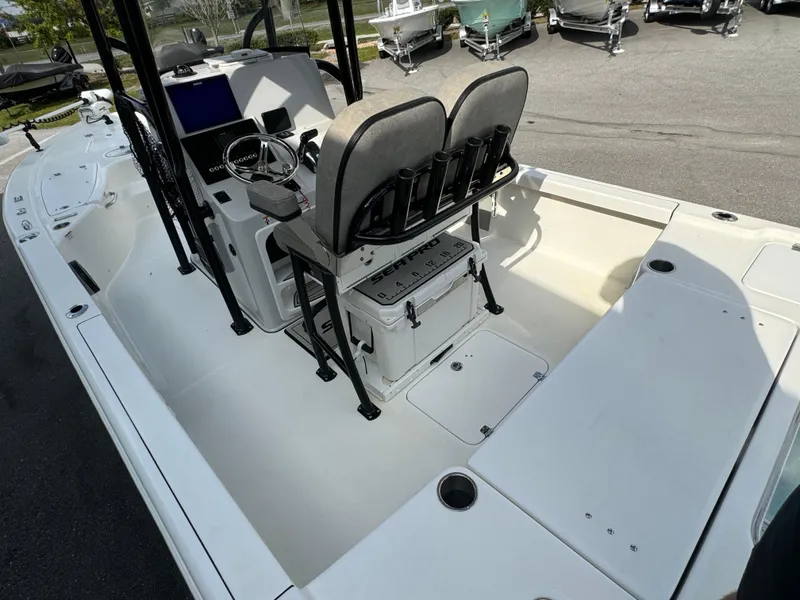 Slide: The Image of 2024 Sea Pro 248 boat interior with dual seats and steering console. - 14