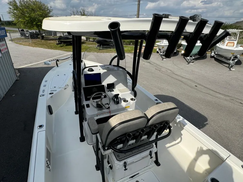 Slide: The Image of 2024 Sea Pro 248 boat interior with helm, seating, and rod holders. - 15