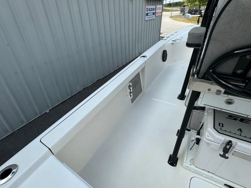 Slide: The Image of 2024 Sea Pro 248 boat interior, featuring sleek white deck and seating area. - 16