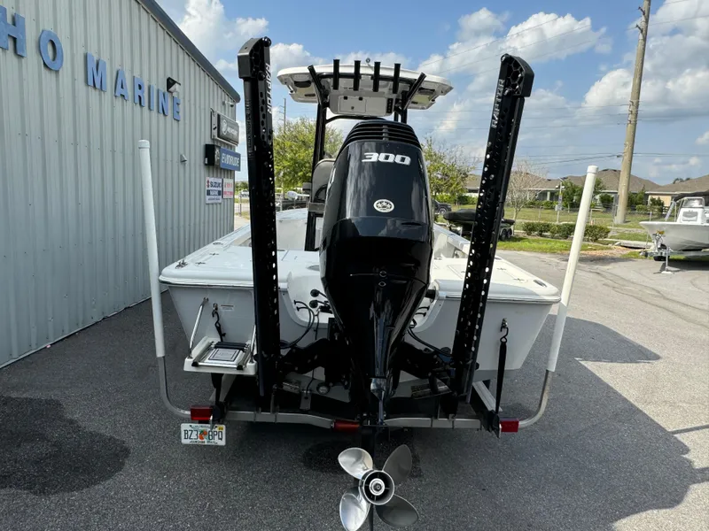 Slide: The Image of 2024 Sea Pro 248 boat with powerful 300 engine, parked outside a marine dealership. - 24