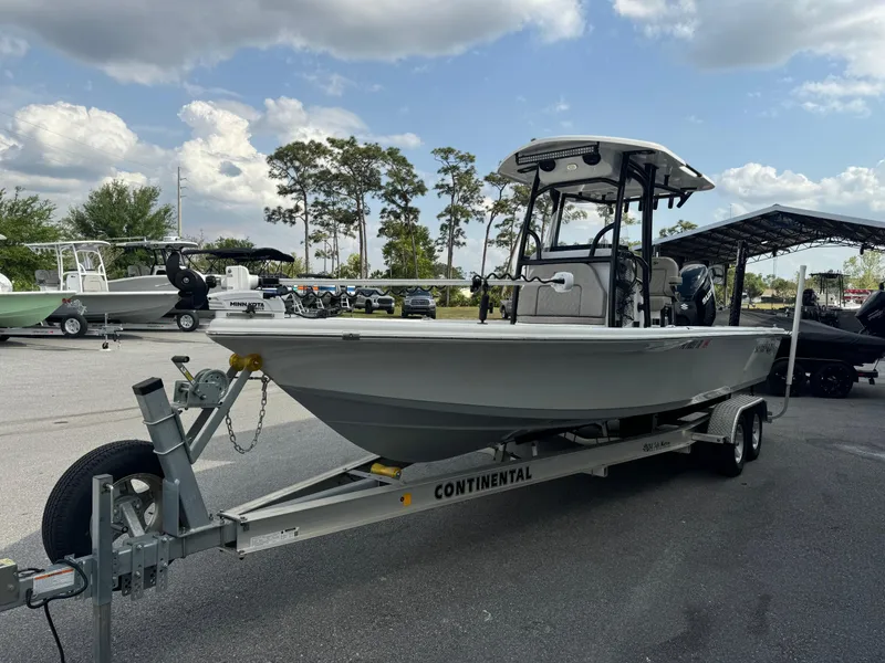 Slide: The Image of 2024 Sea Pro 248 boat on trailer, parked outdoors under cloudy sky. - 3