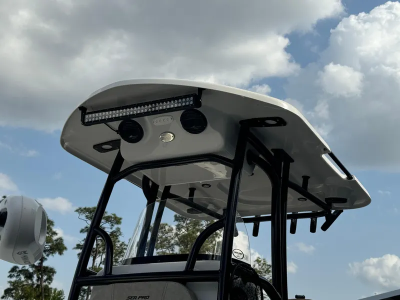 Slide: The Image of 2024 Sea Pro 248 boat T-top with LED lights against a cloudy sky. - 4