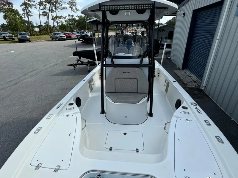 Slide: The Image of 2024 Sea Pro 248 boat with spacious deck and modern design, parked outdoors. - 7