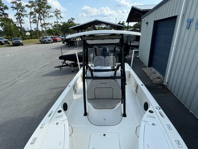 Slide: The Image of 2024 Sea Pro 248 boat at a marina, featuring a sleek design and spacious deck. - 8