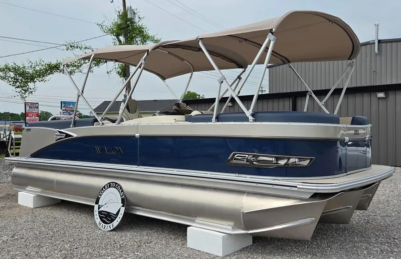 The Image of 2025 Avalon Platinum Catalina 2585 Quad Lounger pontoon boat with canopy, parked outdoors. - 0