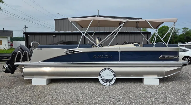 Slide: The Image of 2025 Avalon Platinum Catalina 2585 Quad Lounger pontoon boat with canopy, parked on gravel. - 3