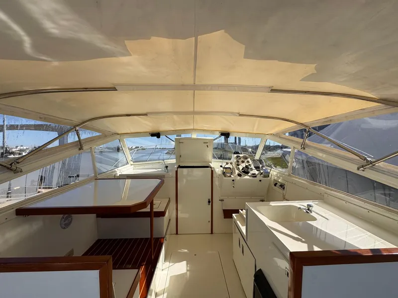 Slide: The Image of 1977 Bertram 28 Moppie boat interior with helm, seating, and canopy. - 15