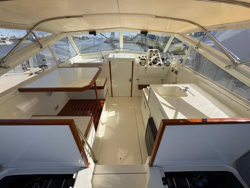 Slide: The Image of 1977 Bertram 28 Moppie boat interior with helm, seating, and wooden accents. - 16