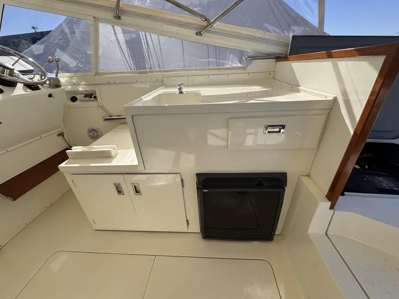 Slide: The Image of 1977 Bertram 28 Moppie boat interior with sink and storage cabinets. - 18
