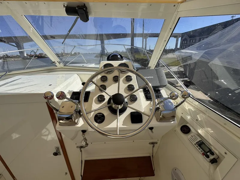 Slide: The Image of 1977 Bertram 28 Moppie boat helm with steering wheel and control panel. - 23