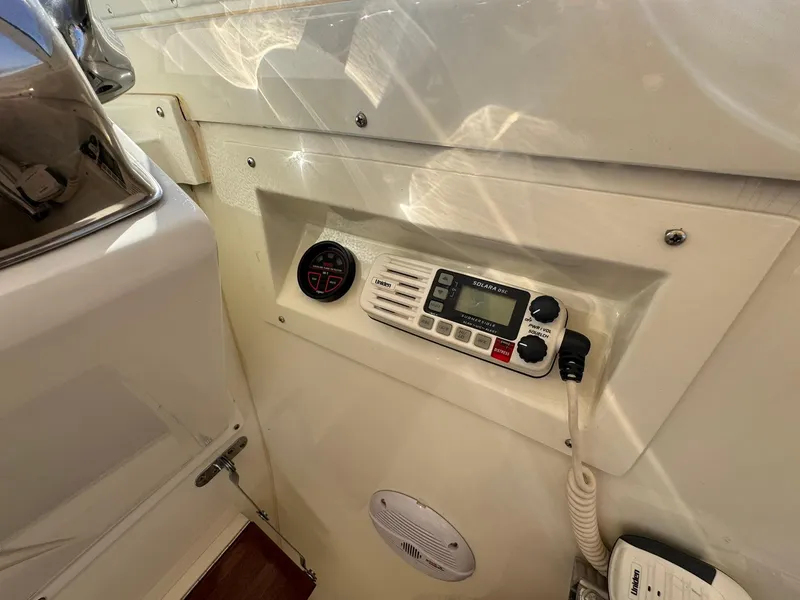 Slide: The Image of 1977 Bertram 28 Moppie boat dashboard with radio and gauge. - 26