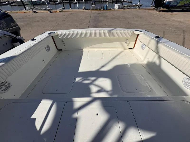 Slide: The Image of 1977 Bertram 28 Moppie boat interior, spacious deck, docked at marina. - 28