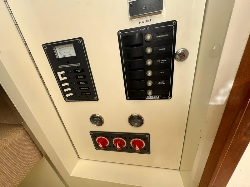 Slide: The Image of Electrical panel of a 1977 Bertram 28 Moppie boat with switches and gauges. - 32