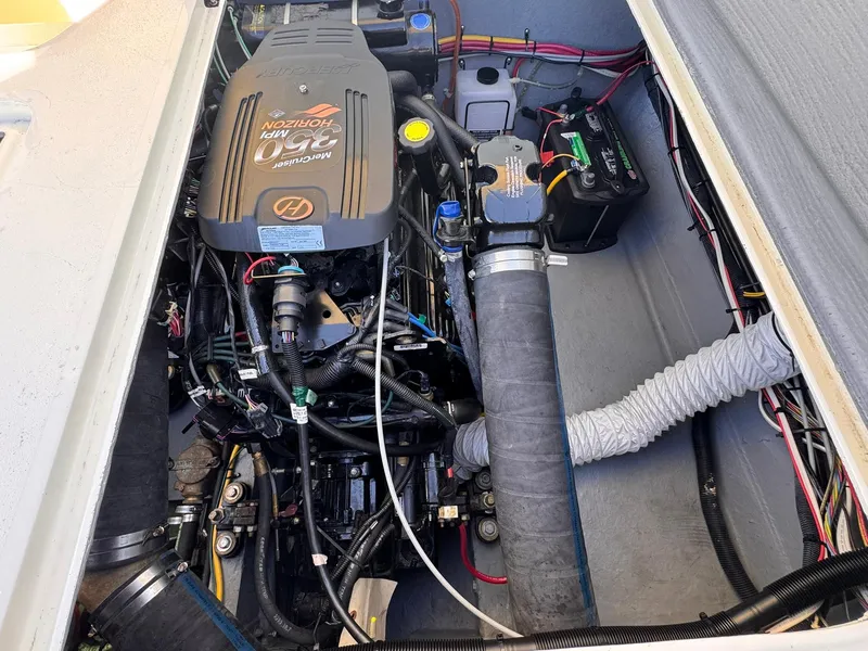 Slide: The Image of Engine compartment of a 1977 Bertram 28 Moppie boat, showcasing detailed mechanical components. - 33
