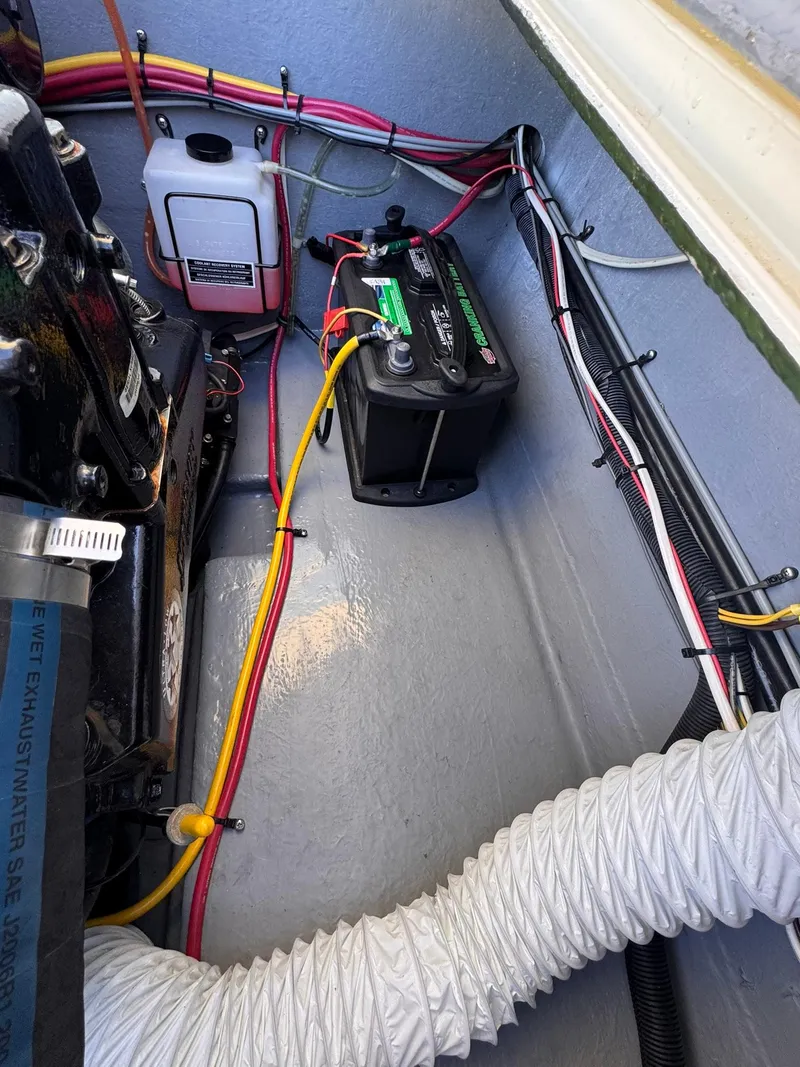 Slide: The Image of 1977 Bertram 28 Moppie engine compartment with battery and wiring setup. - 36