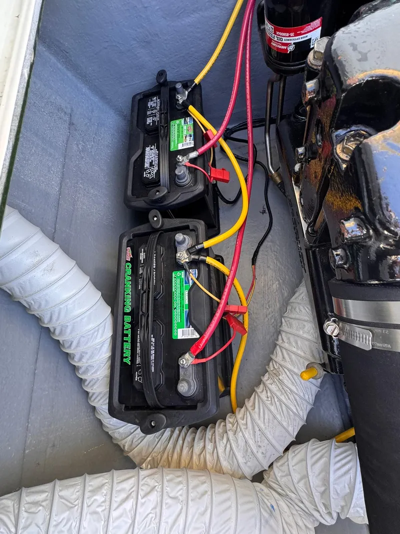 Slide: The Image of 1977 Bertram 28 Moppie boat engine compartment with dual batteries and wiring. - 37