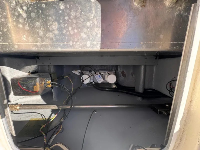 Slide: The Image of 1977 Bertram 28 Moppie engine compartment with wiring and components visible. - 38