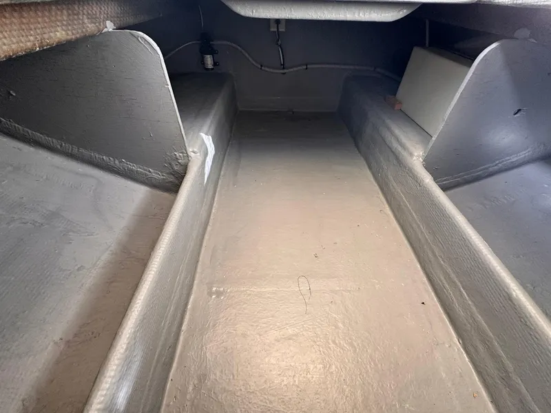 Slide: The Image of Interior view of a 1977 Bertram 28 Moppie boat, showcasing storage compartments. - 39