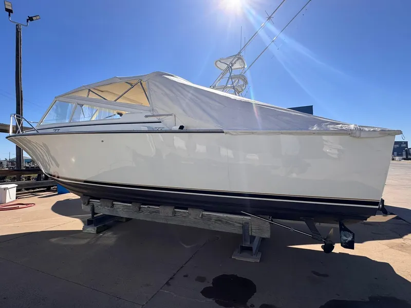 Slide: The Image of 1977 Bertram 28 Moppie boat on dry dock under clear blue sky. - 7