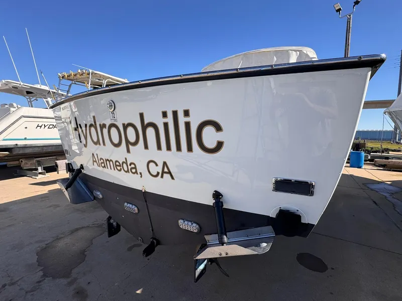 Slide: The Image of 1977 Bertram 28 Moppie boat named "Hydrophilic" in Alameda, CA, docked under clear blue sky. - 8