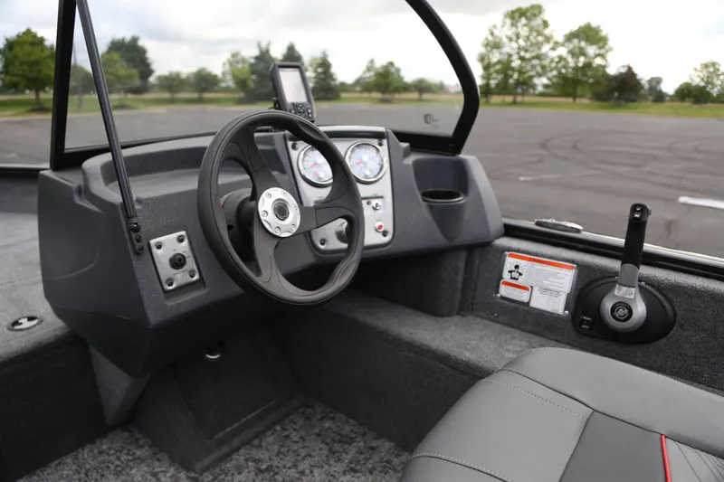 Slide: The Image of 2025 Tracker Pro Guide V-16 WT boat interior with steering wheel and dashboard controls. - 4