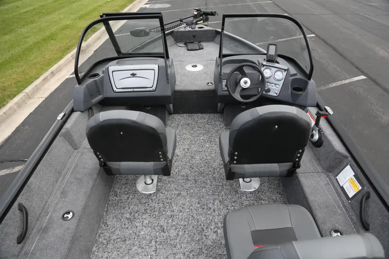 Slide: The Image of 2025 Tracker Pro Guide V-16 WT boat interior with dual seats and steering console. - 5
