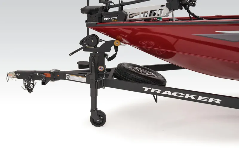 Slide: The Image of 2025 Tracker Savage 215 boat interior with gray and red seats, steering wheel visible. - 6