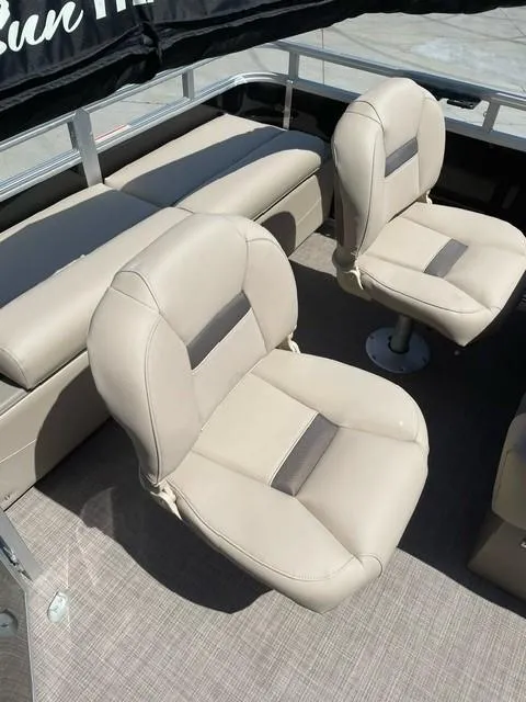 Slide: The Image of 2025 Sun Tracker SportFish 22 DLX pontoon boat, rear view, parked outdoors. - 4