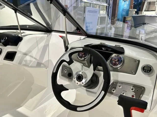 Slide: The Image of 2025 Tahoe 200 S boat dashboard with steering wheel and control panel. - 4
