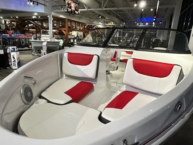 Slide: The Image of 2025 Tahoe 200 S boat interior with red and white seating in showroom. - 6
