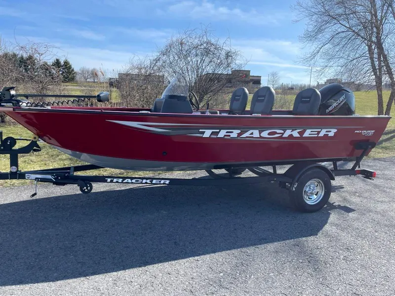 Slide: The Image of 2025 Tracker Pro Guide V-16 SC boat, red, on trailer, parked outdoors. - 3