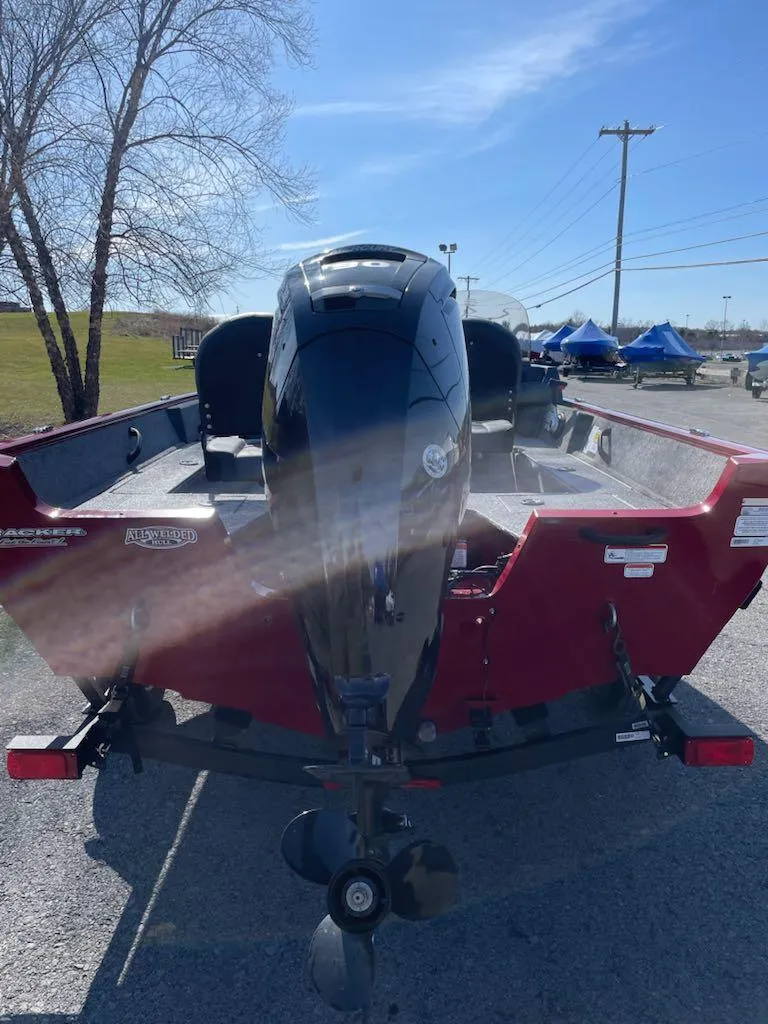 Slide: The Image of 2025 Tracker Pro Guide V-16 SC boat, rear view, parked outdoors on a sunny day. - 4