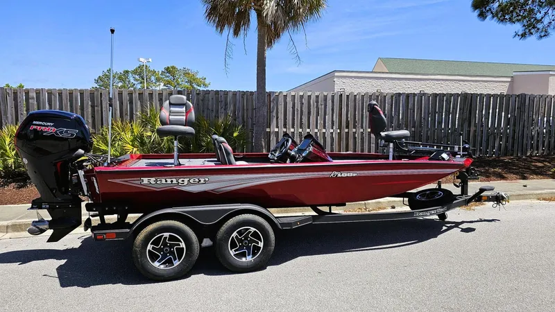The Image of 2025 Ranger RT188P bass boat in red, parked on a trailer, side view. - 0