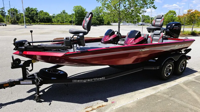Slide: The Image of 2025 Ranger RT188P bass boat in parking lot, red color, dual seats, on trailer. - 10