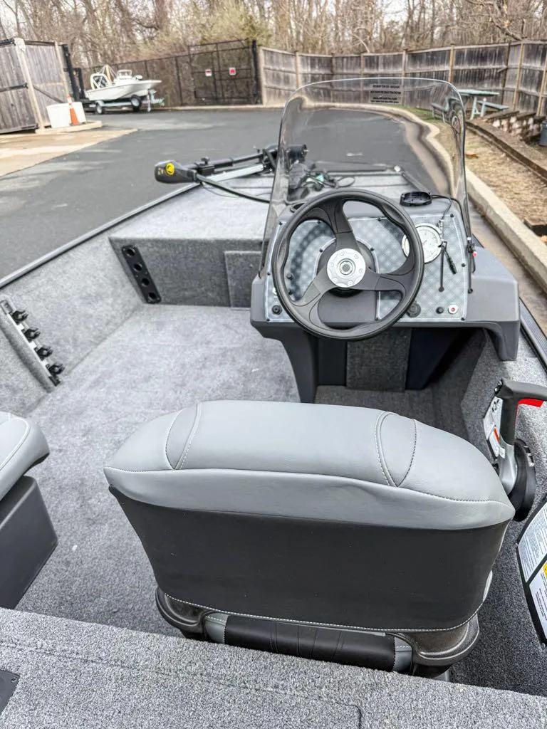 Slide: The Image of 2025 Tracker Bass Tracker Classic XL boat interior with steering wheel and seating. - 3