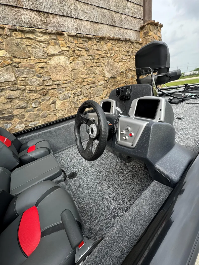 Slide: The Image of 2025 Tracker Pro Team 175 boat interior with steering wheel and dual seats. - 3