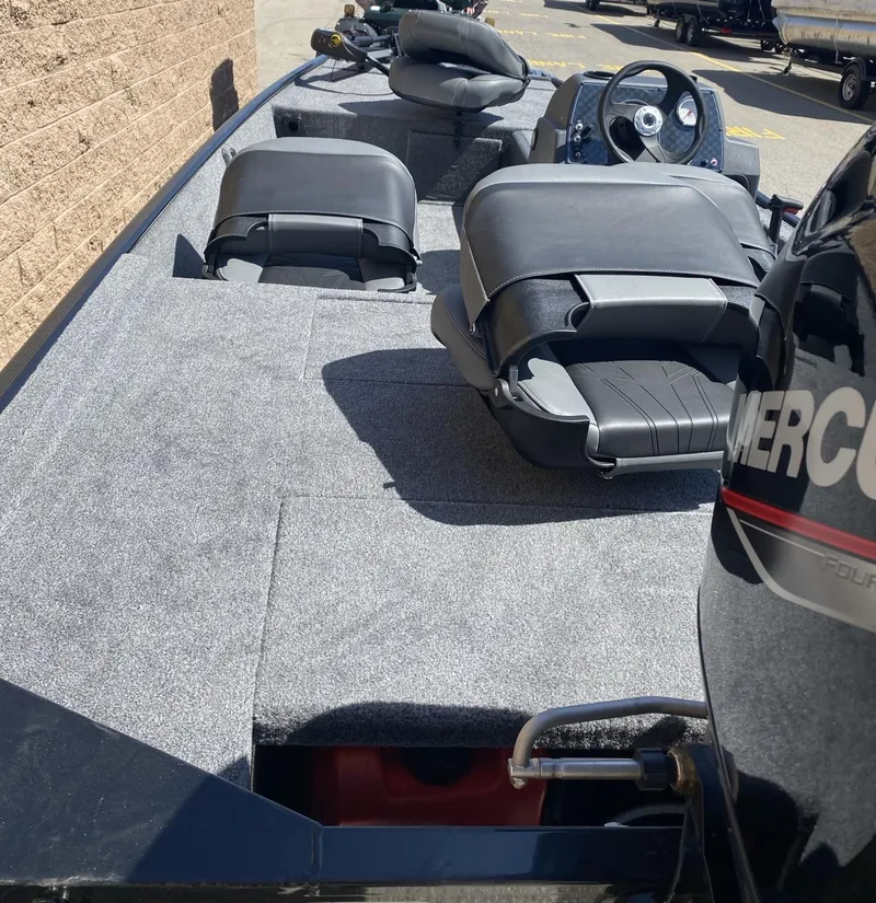 Slide: The Image of 2025 Tracker Bass Tracker Classic XL boat interior with seating and steering console. - 4