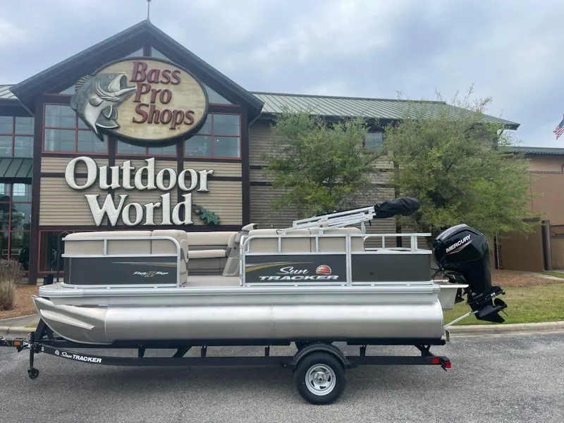 Slide: The Image of 2025 Sun Tracker Party Barge 18 DLX pontoon boat outside Bass Pro Shops. - 5