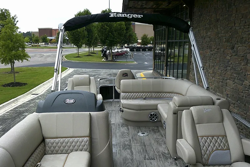 Slide: The Image of 2025 Ranger Reata 220FC pontoon boat with luxurious seating and modern design. - 4