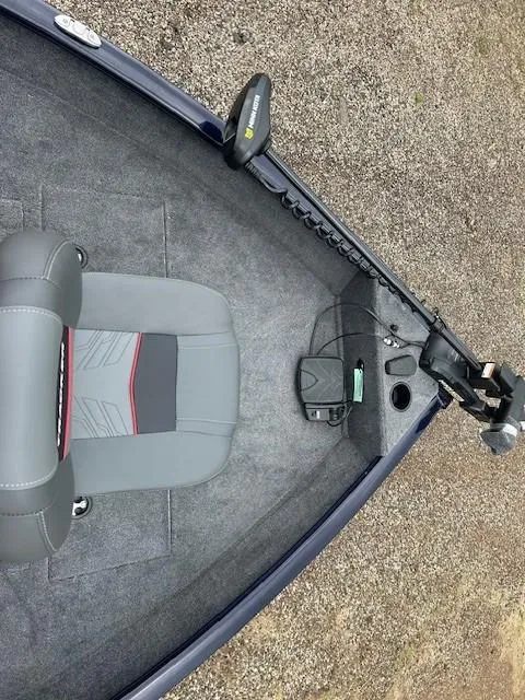 Slide: The Image of 2025 Tracker Pro Guide V-16 SC boat interior with gray seating and trolling motor. - 11